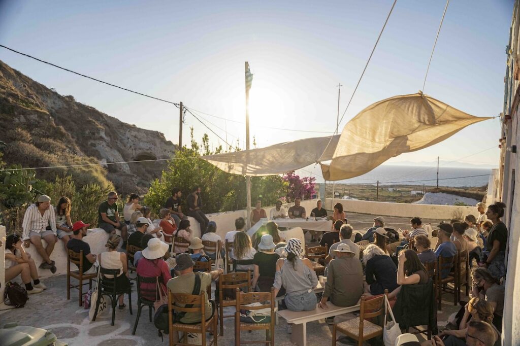 gathering of people listening to a talk on outside terrace