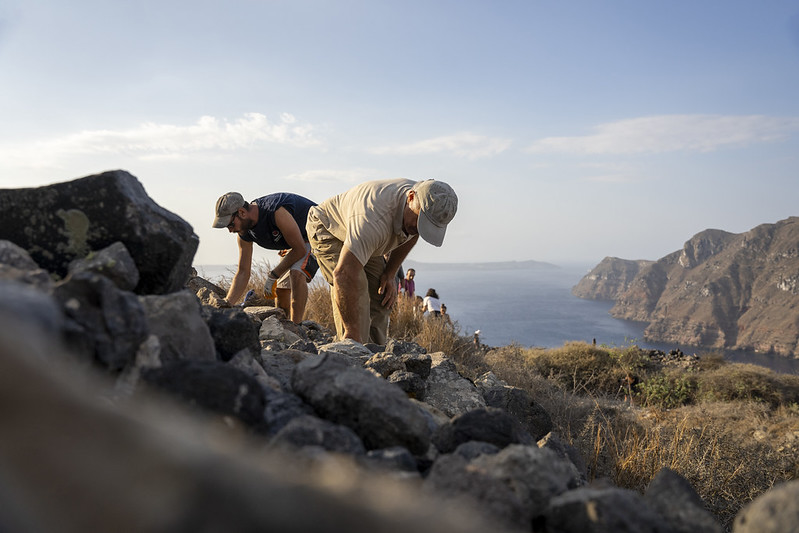 building work underway with sea and cliffs behind