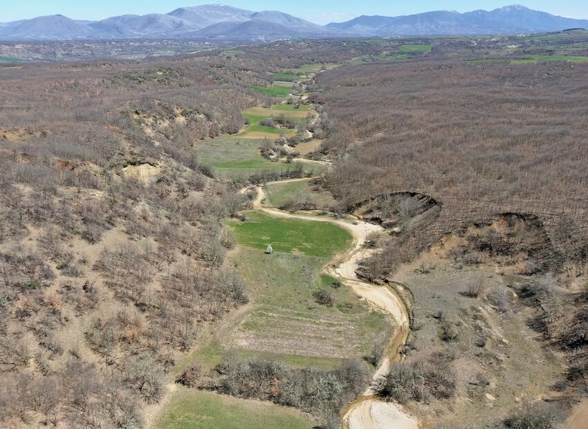 River valley with mountains in distance.